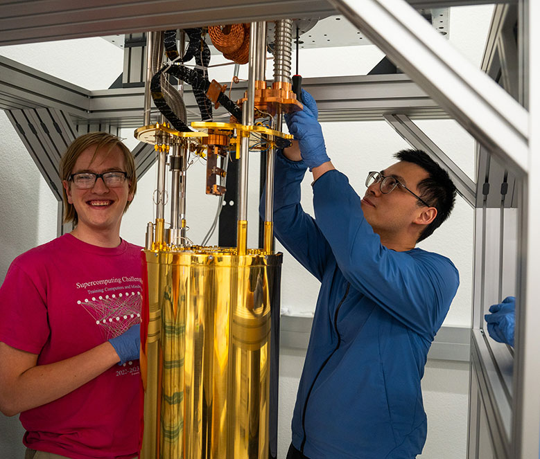 Two students working on scientific instrument